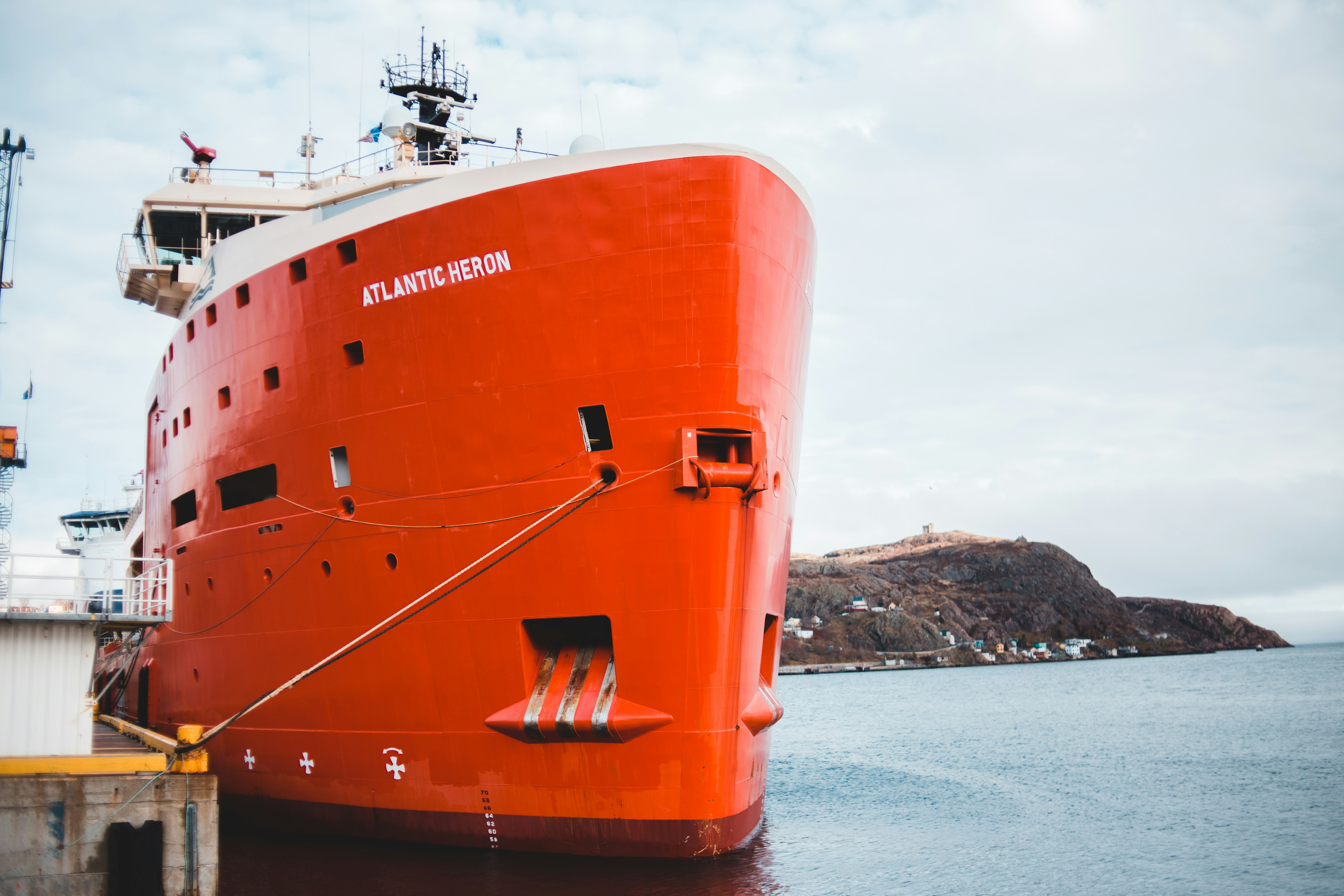 orange and white ship on sea during daytime